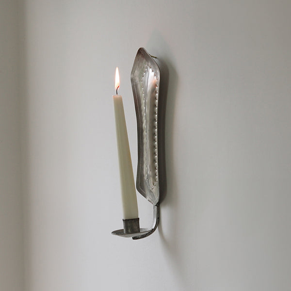 Romantic pewter wall sconce handcrafted in Finland, circa 1940, reflecting Finnish handicrafts and mid-century Scandinavian design.