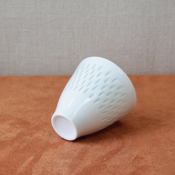 Midcentury small porcelain vase by Friedl Holzer-Kjellberg with a pierced rice grain decor, a notable piece for collectors of vintage design. Available at Art & Utility in London.