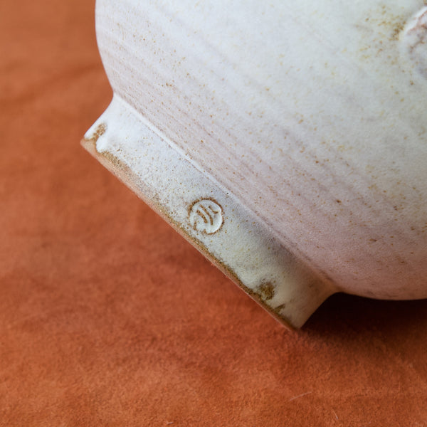 Close up of Emmanuel cooper makers mark potters seal on a tureen from the 1960s with a greco-roman inspired silhouette.