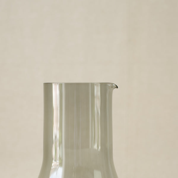 A 1963 Kaj Franck collectible pitcher, mould-blown by Nuutajärvi Notsjö. This iconic piece of Finnish glassware combines vintage beauty with timeless functionality.