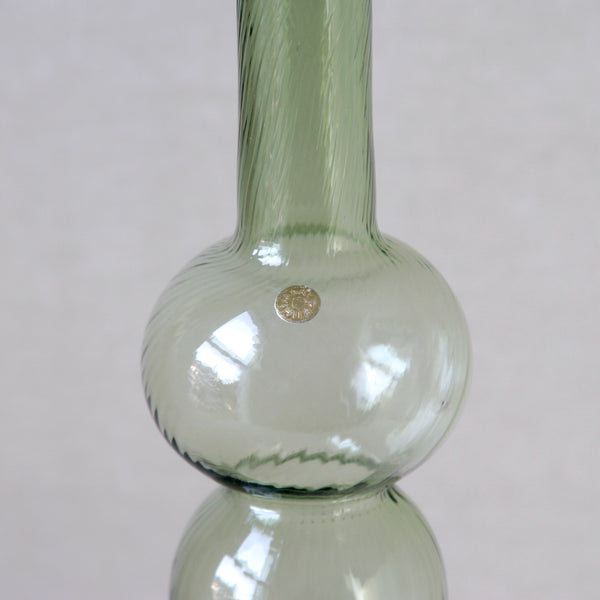 A stickered example of Nanny Still Neptuna vase, crafted with an optical mould for Riihimaen Lasi Oy, a 1960s Scandinavian design icon.