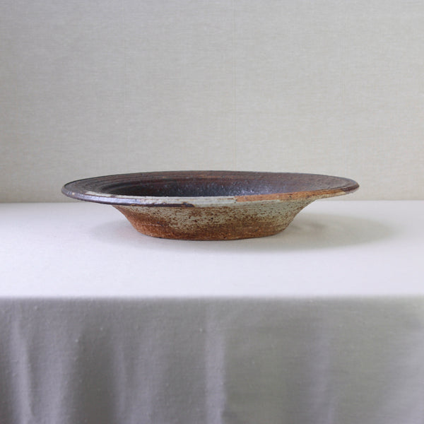 Handmade mid-century modern art bowl by Annikki Hovisaari for Arabia Finland, crafted with a coarse chamotte clay texture.