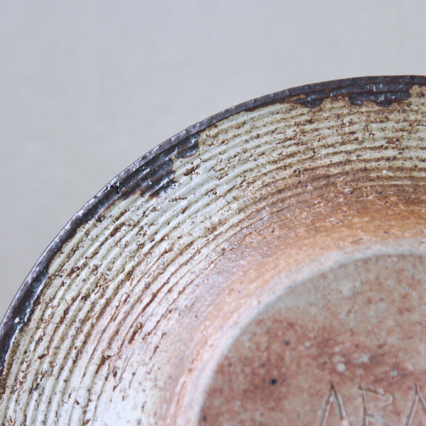 Detail of mid-century modern art bowl by Annikki Hovisaari for Arabia Finland, a large, rustic piece in earthy hues with a dynamic glaze.