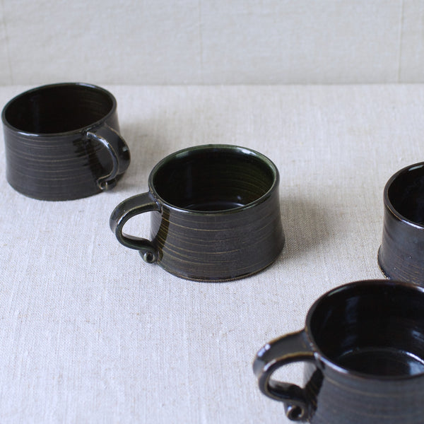 These 1957 hand-thrown stoneware cups by Kaarina Aho for Arabia blend functional modernism with earthy organic design. Available for sale now.