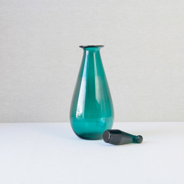 Nanny Still SV decanter, turquoise, crafted by Riihimaki Glassworks in the 1950s, showcasing Finnish modernist style.