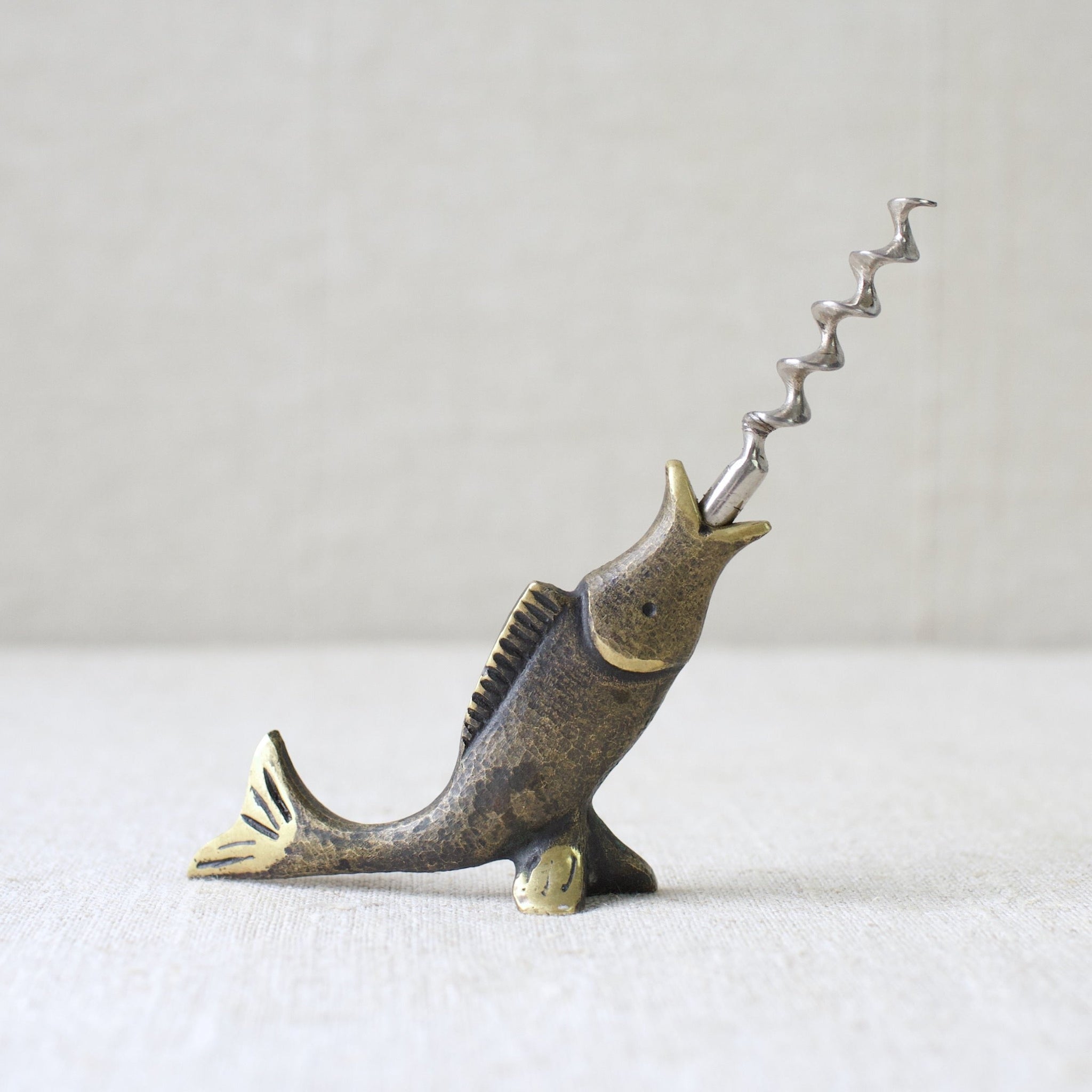 This rare brass fish corkscrew by Walter Bosse, crafted by Herta Baller in 1950s Vienna, is a perfect representation of mid-century Modernist metalwork from Austria.