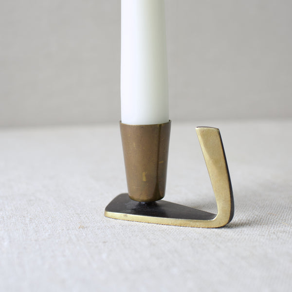 Karl Hagenauer's brass candle holder, designed in 1950s Vienna, combines the elegance of Art Deco with sleek Modernist lines. This highly collectible item embodies the precision of Austrian metalwork.