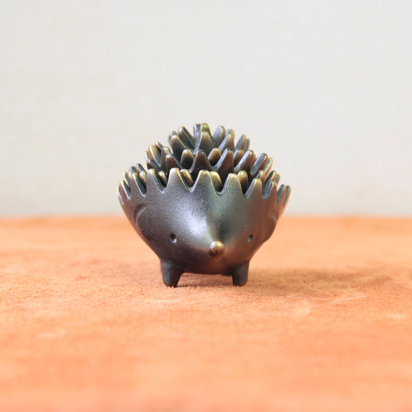 A genuine hedgehog ashtray by Walter Bosse, crafted in the mid-century Modernist style. This collectible piece exemplifies Bosse's renowned creativity and whimsical charm in Viennese metalwork.