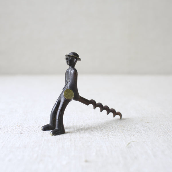 Richard Rohac's 1950s "Vagabond" brass corkscrew, featuring a patinated finish, embodies the Modernist Viennese metalwork of the era. A collectible piece sought after by mid-century design enthusiasts.