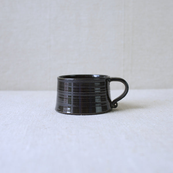 Profile view of a vintage 1950s 1960s Arabia stoneware cups by Kaarina Aho, featuring a unique treacle glaze and textured design. Rare find from Finland’s mid-century modern era.