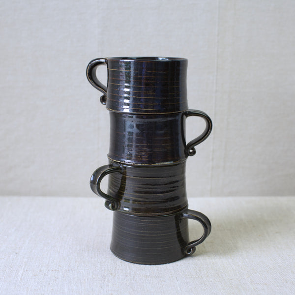 For sale: A set of four vintage Kaarina Aho-designed stoneware cups, hand-thrown and hand-glazed at Arabia, Finland, with a treacle-like glaze.