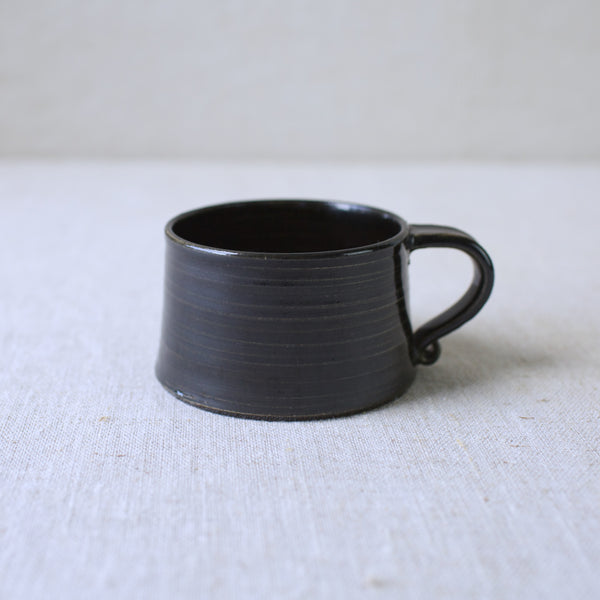 Student of Kaj Franck, Kaarina Aho’s 1957 unique stoneware cup for Arabia, hand-thrown with a textured treacle glaze. Available for sale in London from Scandinavian design gallery Art and Utility.