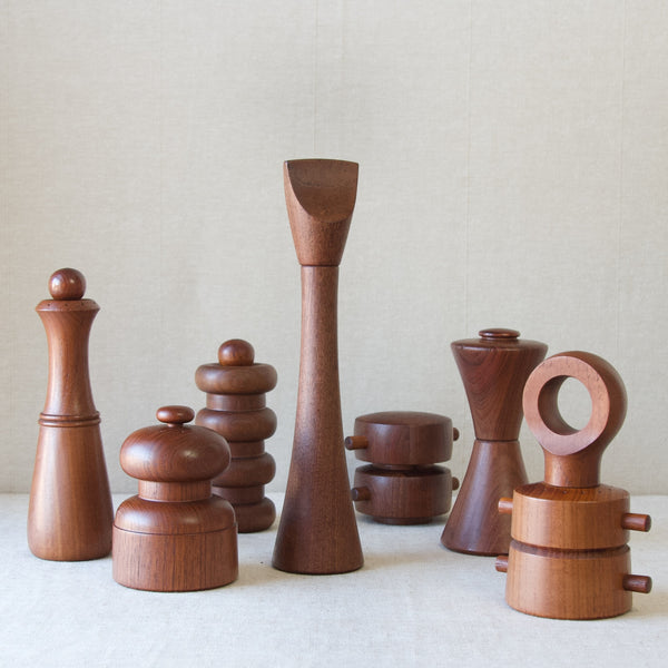 Mood image showing a group of teak wood pepper mill in a huge variety of strange and interesting shapes. Each of the seven peppermills in the image were designed by leading Danish sculptor Jens Quistgaard who did an incredible amount in popularising Scandinavian Organic Modernism in the Mid-twentieth century.