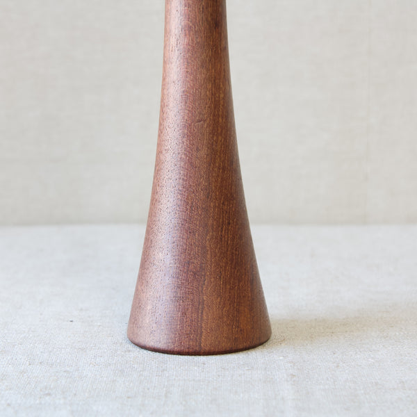 Zoomed in detail of the base of a Jens Quistgaard pepper mill. This design is turned from one piece of teak wood and stands 32 cm tall. The design, called "Screwdriver", is early in Quistgaard's work and few were produced compared to others in his collection.