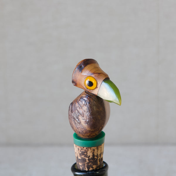 Art Deco YZ bird bottle stopper, made from a tagua nut with bakelite beak with yellow glass eyes. Produced by Henry Howell for Dunhill, 1920's, London.