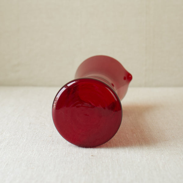 A hand-blown ruby red cocktail pitcher by Kaj Franck from 1954, reflecting the excellence of Finnish glassmaking.