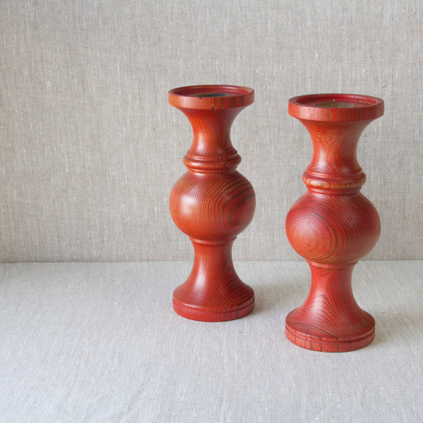 Red stained pine candlesticks by lena Larsson for Boda Tra, Sweden, emulating traditional Swedish crafts & design