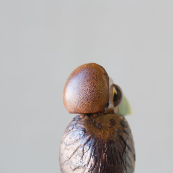 Close up of the bamboo head on Henry Howell nut bird corked bottle stopper.