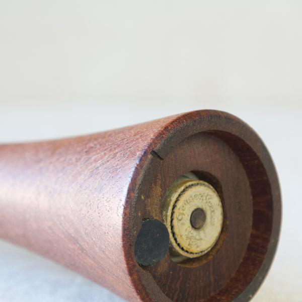Close up showing a small indentation to the teak wood of a Danish pepper mill designed by Jens H. Quistgaard.