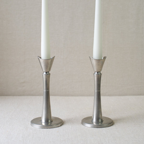 A pair of GAB Tenn pewter candlesticks in the Swedish Grace style, for sale from Nordic design gallery Art & Utility. Iconic Scandinavian design with modernist appeal.