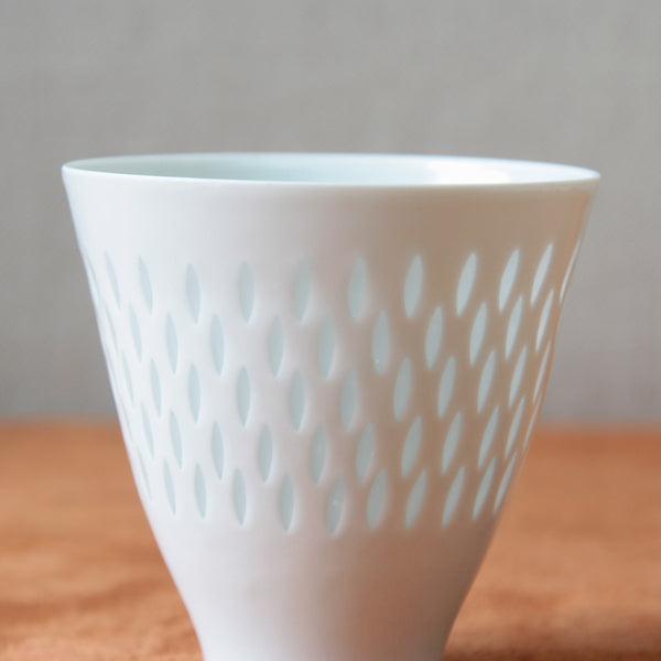 Porcelain vase by Friedl Holzer-Kjellberg with unique rice grain holes, representing a stunning example of Nordic design from the 1950s. Purchase this piece at Art & Utility, London.