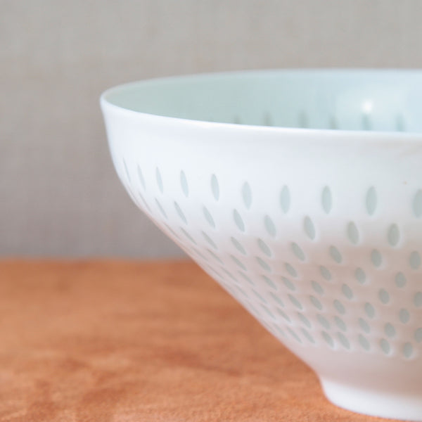 Large pierced porcelain bowl designed by Friedl Holzer-Kjellberg with a rice grain pattern, a vintage collectible.