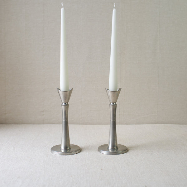 Nordic GAB Tenn pewter candlesticks from the mid-century modern era. These collectible Swedish Grace candlesticks are available for sale at Art & Utility.