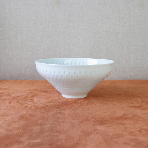 Handmade porcelain bowl by Friedl Holzer-Kjellberg with early rice grain technique, representing 1950s Nordic design.