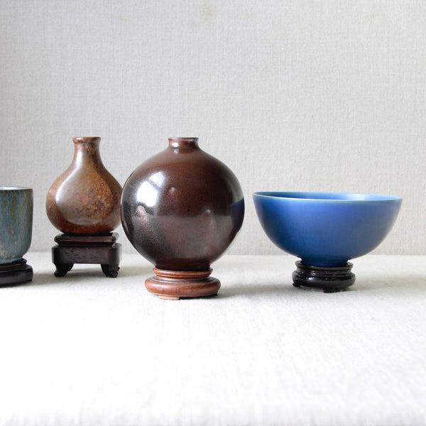 Artistic mood group shot. Featuring Palshus 1950s modernist bowl, blue haresfur glaze, by Per & Annelise Linneman-Schmidt. Photograph highlights how mid-century Scandinavian ceramics borrowed heavily from East Asian ceramics.