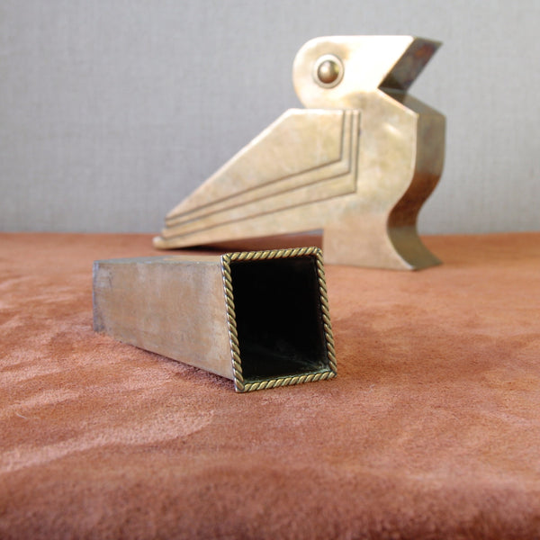 Collectible British brass bird sculpture featuring Art Deco geometry and Egyptian-inspired style, perfect for vintage decor lovers.