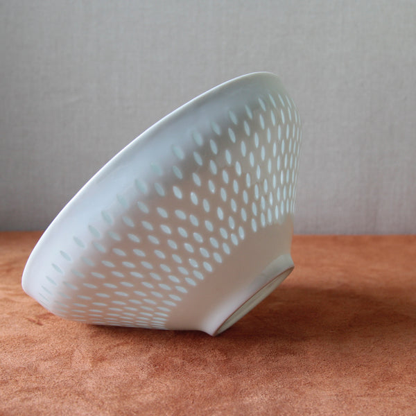 Vintage porcelain bowl by Friedl Holzer-Kjellberg with a full-surface rice grain pattern, a significant piece of Scandinavian design history.