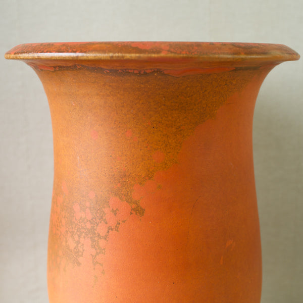 Close up of a rare exquisite orange-glazed earthenware floor vase designed by Svend Hammershøi for Kähler Pottery.