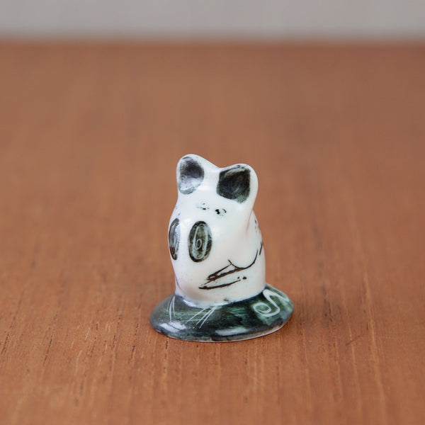 Life-sized ceramic mouse figurine by Susan Parkinson with an oval body and artistic details, viewed from the top.