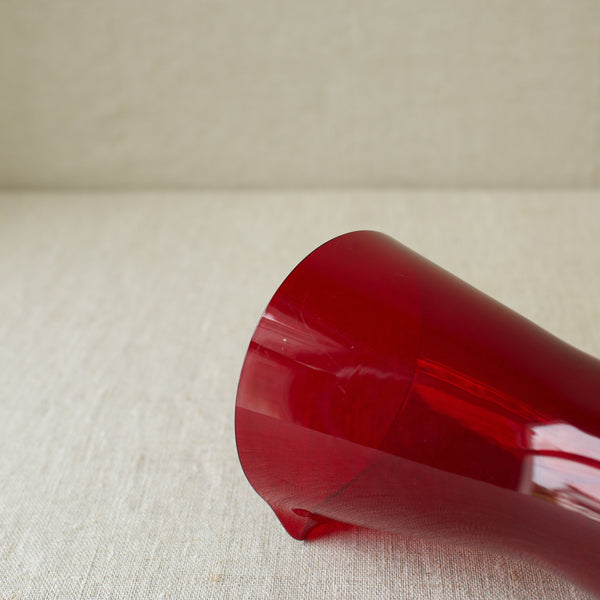 A rare ruby red geometric cocktail pitcher by Kaj Franck from 1954, showcasing iconic Nordic design.