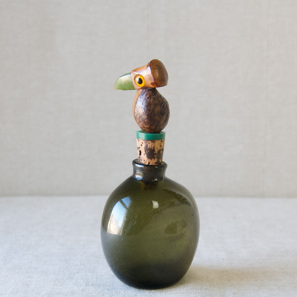 Antique green glass round bottle with a YZ bird nut bottle stopper, produced by Henry Howell in the 1920's for Dunhill