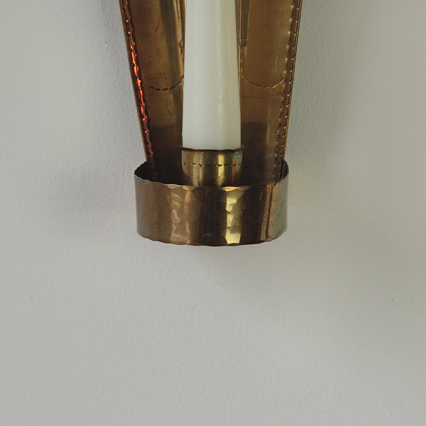 Delicate chased lines and fluted backplates in Carl Malmstedt's brass wall sconces, handcrafted in 1932 and 1933 in Sweden, exemplifying nordic design.