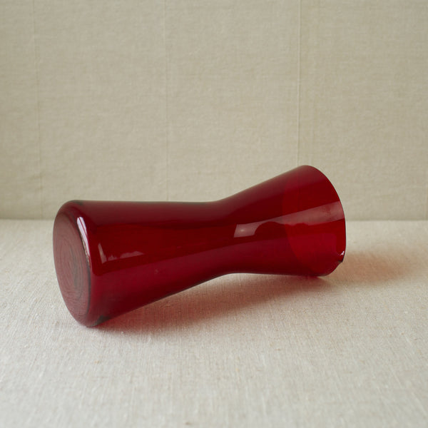 The 1610 ruby red cocktail pitcher, designed by Kaj Franck in 1954, is a standout example of mid-century glass design.