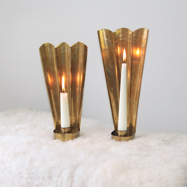 Nonmatching pair of brass sconces by Carl Malmstedt, showcasing Swedish handicrafts and the national emblem, handcrafted in 1932 and 1933.