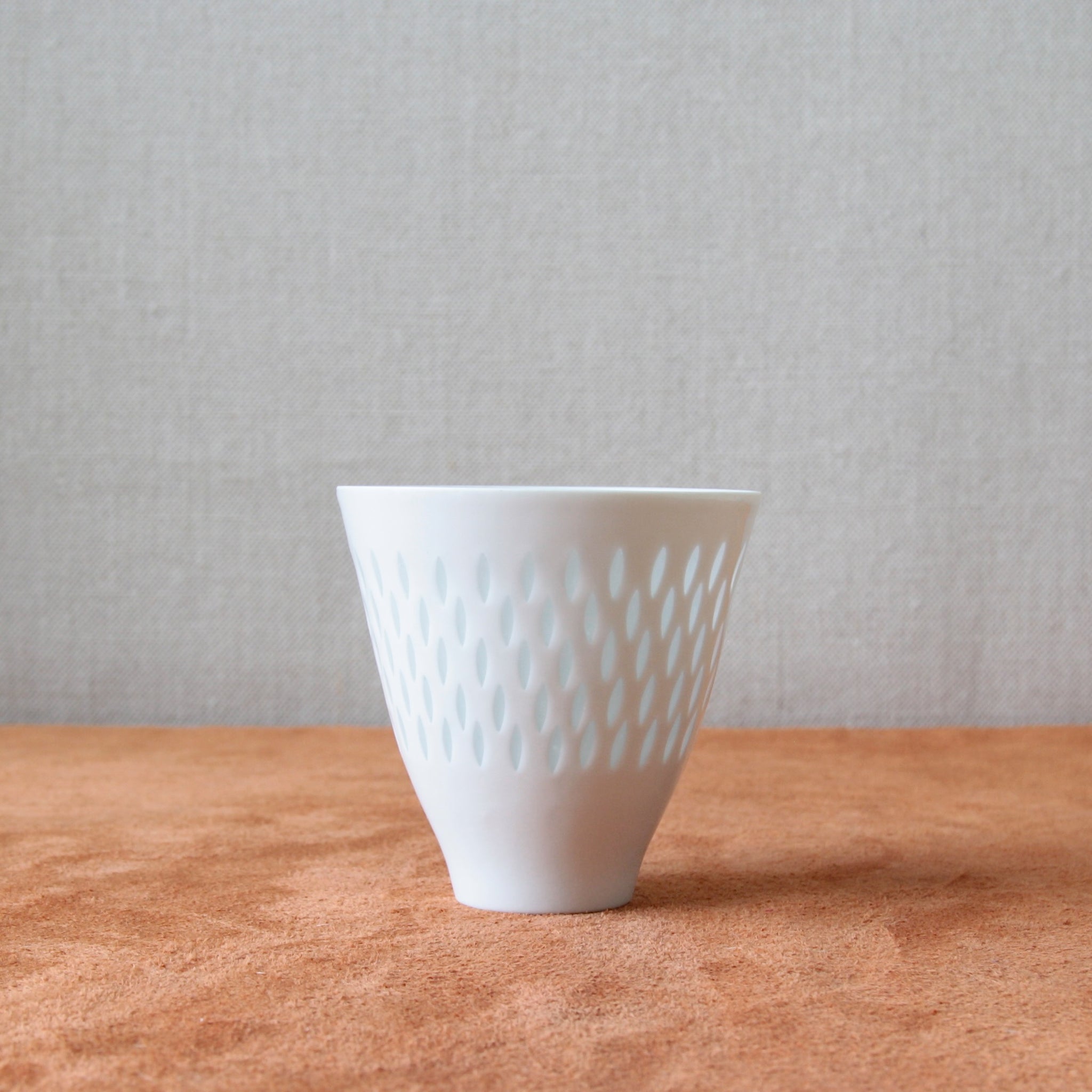 Small porcelain vase by Friedl Holzer-Kjellberg featuring intricate rice grain decoration, designed circa 1955. Available for sale at Art & Utility, a London-based Scandinavian design gallery.