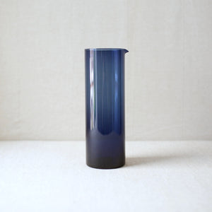 Kaj Franck blue glass pitcher from 1954 featuring a minimalist modernist design.