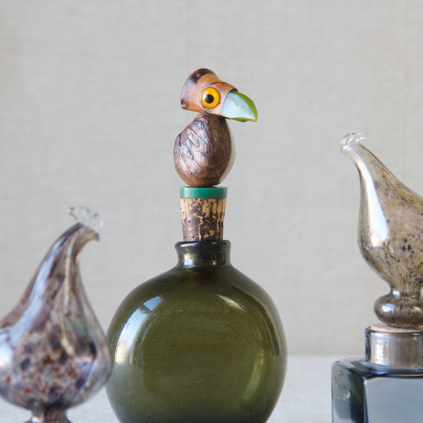 Nut bird YZ bottle stopper by Henry Howell with bakelite beak, surrounded by Finnish glass objects by Kaj Franck in the form of chickens, produced by Nuutajarvi Notsjo.