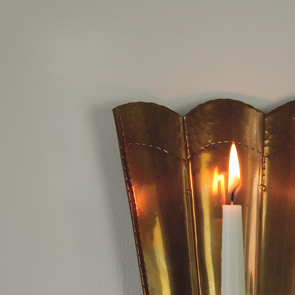 Mesmerizing interplay of shadows and radiance in Carl Malmstedt's brass wall sconces, handcrafted in 1932 and 1933, reflecting twentieth century Swedish metalware.