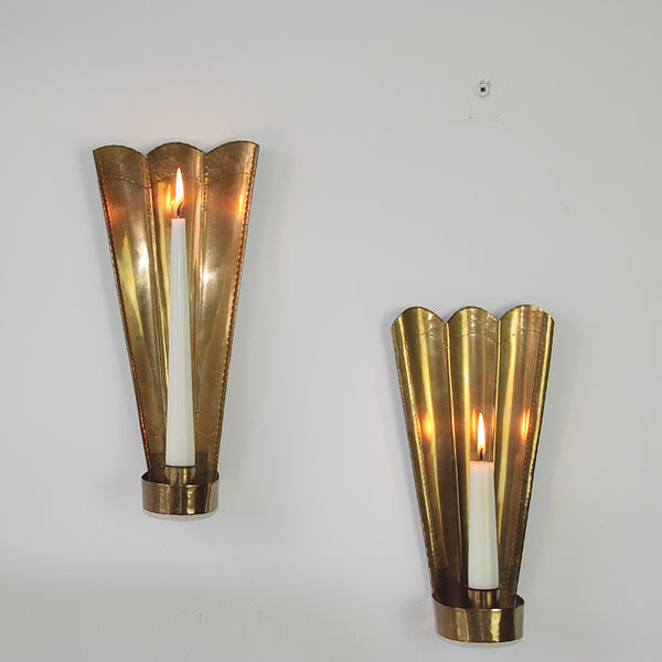 Handcrafted brass wall sconces by Carl Malmstedt, featuring a hammered finish and chased lines, from 1932 and 1933, showcasing Swedish handicrafts.