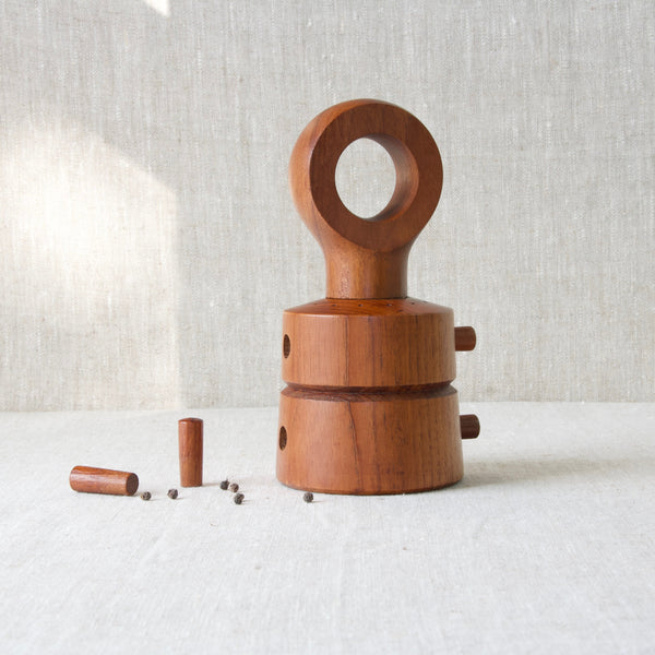 Danish teak peppermill designed by Jens Quistgaard in the shape of an eyelet. A collectable vintage kitchen tool from Denmark.