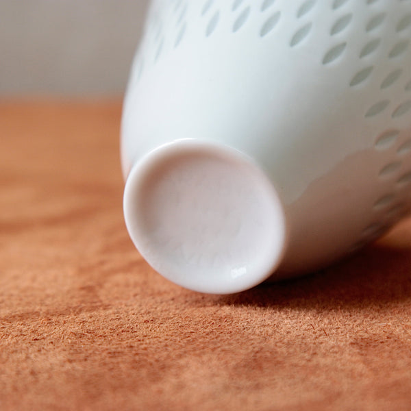 Small porcelain vase with a transparent rice grain pattern by Friedl Holzer-Kjellberg, a distinctive example of 1950s Nordic design. Available for purchase at Art & Utility, London.