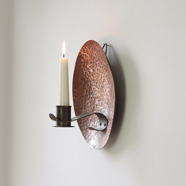 Circular copper wall sconce from 1910, showcasing early 20th-century British arts & crafts design.