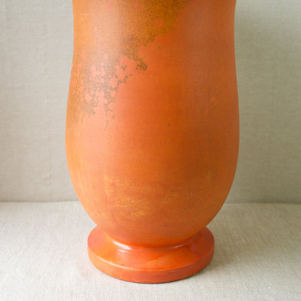 A large orange-glazed baluster vase from Kähler Pottery, circa 1920.