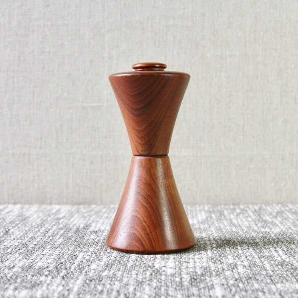 Lead image of a rare Jens H. Quistgaard Combination Pepper & Salt Mill. This model is often referred to as the Hourglass or Diablo on account of its waisted form.