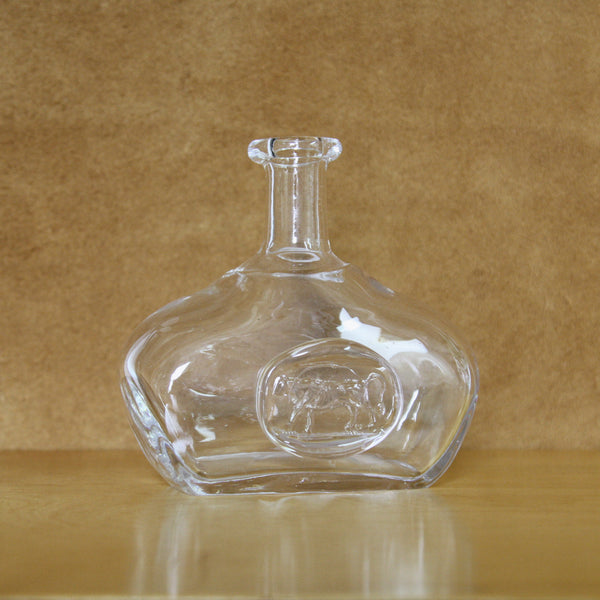 Image of a mid-century clear glass bottle by erik hoglund in natural sunlight