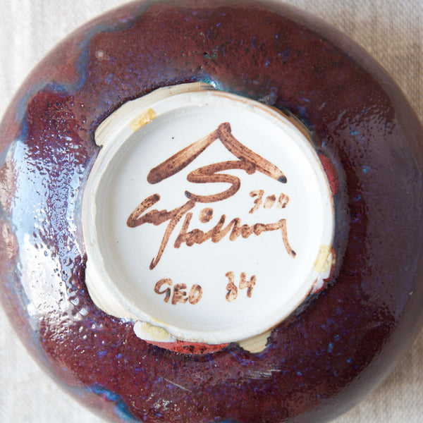 Close up showing the underside of sang de boeuf ox-blood glazed ceramic bowl handthrown by Swedish designer & potter Carl Harry Stalhane.